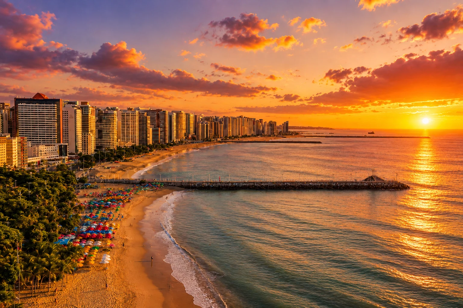 Fortaleza Beira Mar waterfront at sunset with colourful beach umbrellas and the Atlantic Ocean
