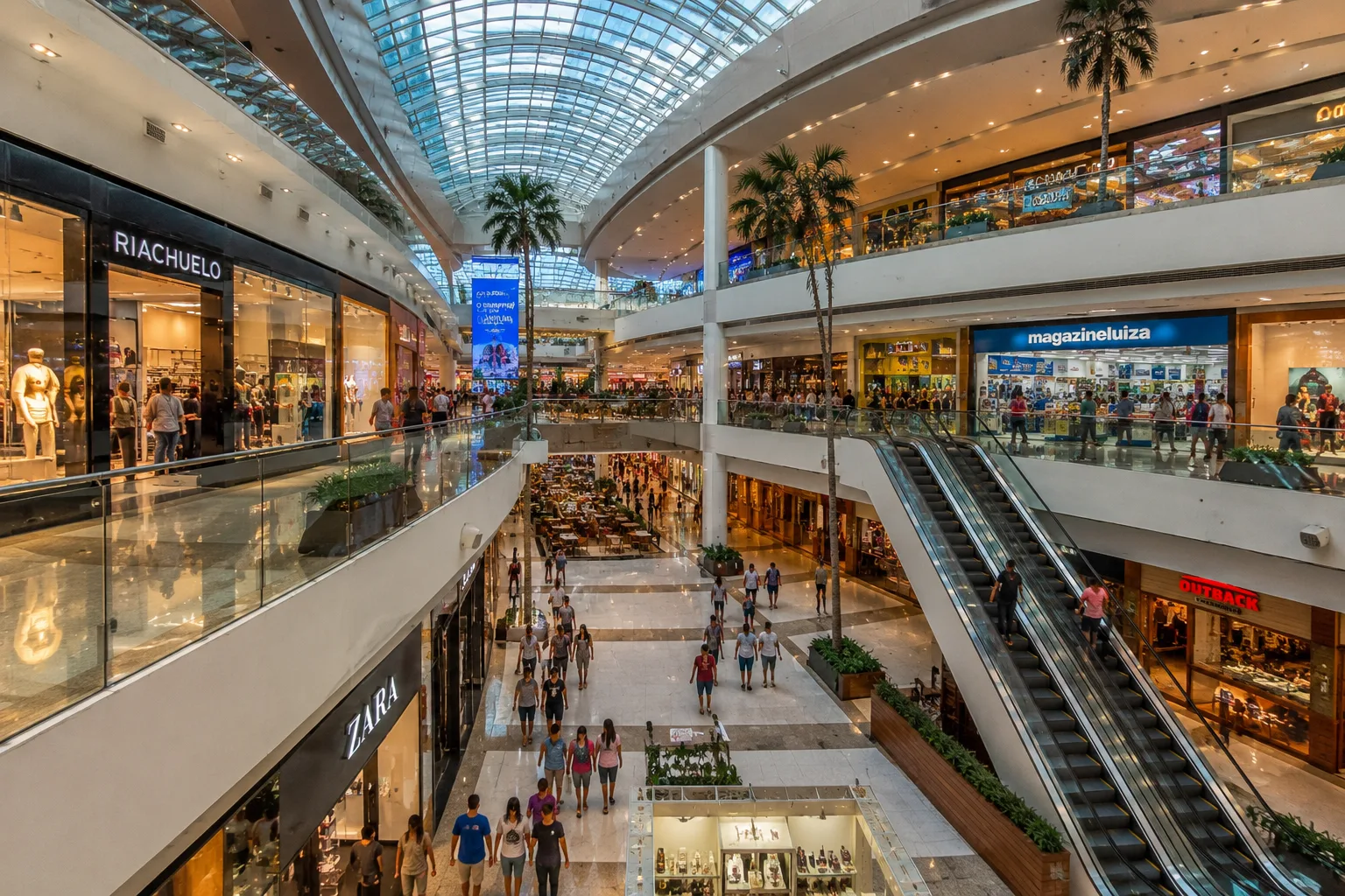 Interior of a large shopping mall in Fortaleza with multiple floors, escalators and palm trees