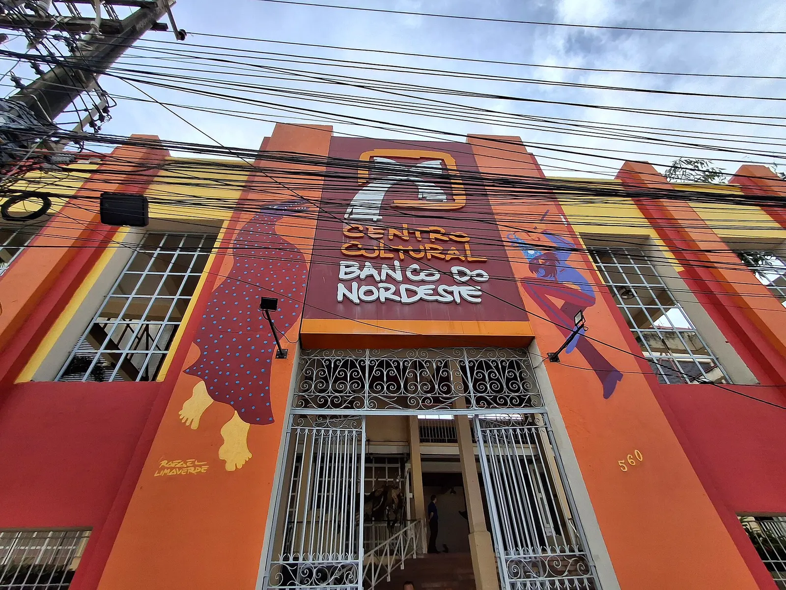 The orange front of the Centro Cultural Banco do Nordeste with painted figures